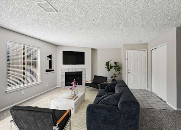A living room with a fireplace and a couch.