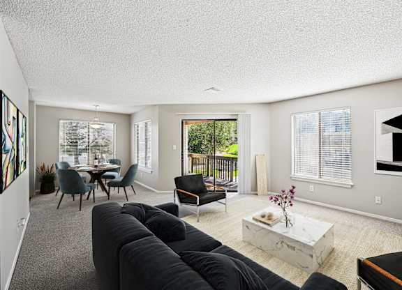 A living room with a grey couch and a coffee table.