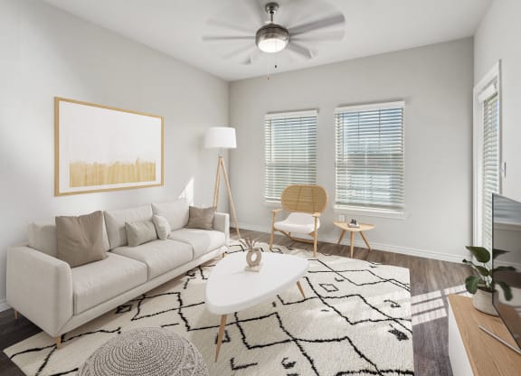 a living room with a white couch and a white coffee table