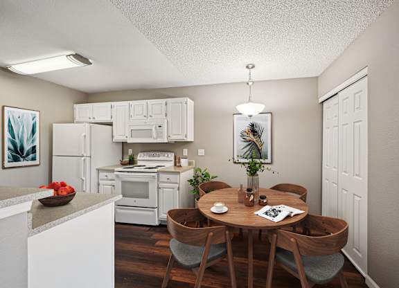 A kitchen with a table and chairs in the middle of it.