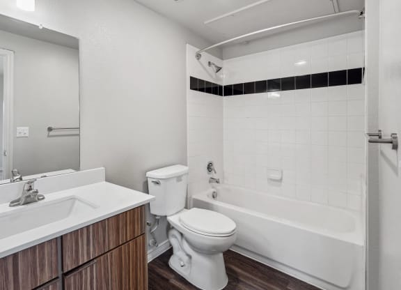 a bathroom with a toilet and a tub and a sink