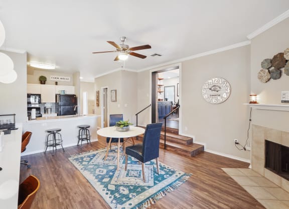 a living room with a fireplace and a ceiling fan