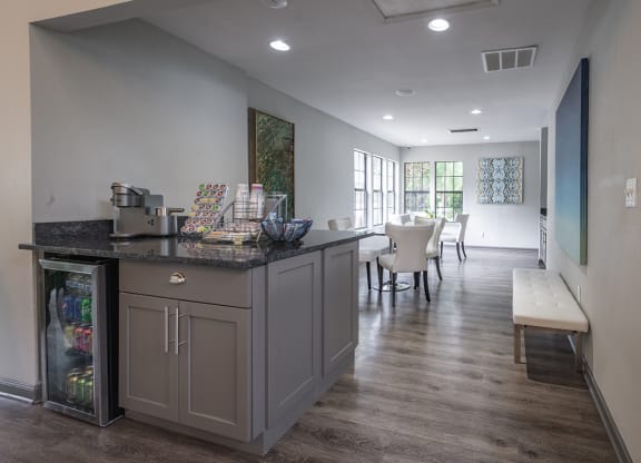 a coffee station with a counter and a seating area in the background