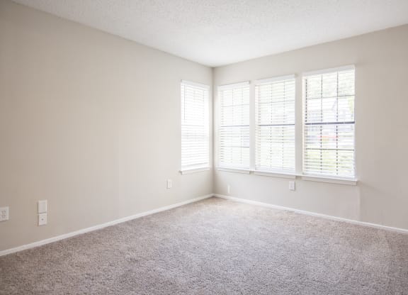 One Bedroom Apartments in Duluth, GA - The Eclipse - Bedroom with Plush Carpet Flooring and Windows with Blinds