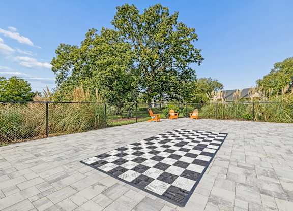 A checkerboard is on a paved area outside.