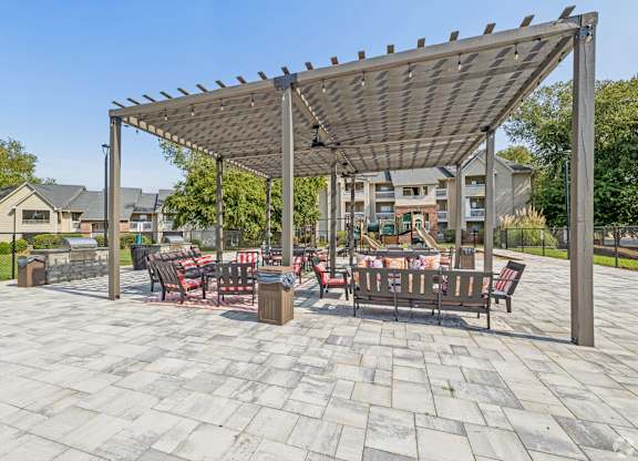 A patio with a table and chairs under a canopy.