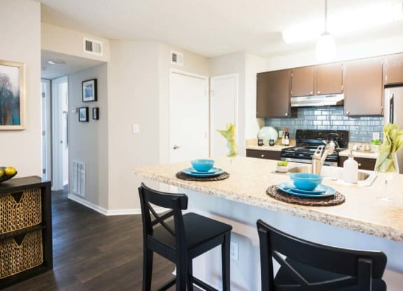 a kitchen with a plates and cups on a counter top at Eclipse Duluth