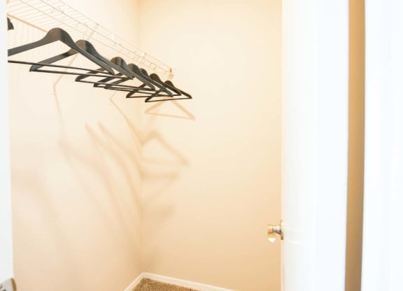 a closet with some clothes hangers on the wall