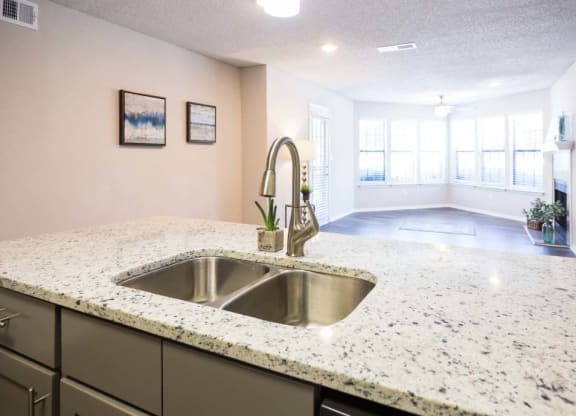 Kitchen Sink with living room in the background at Eclipse Apartments in Duluth