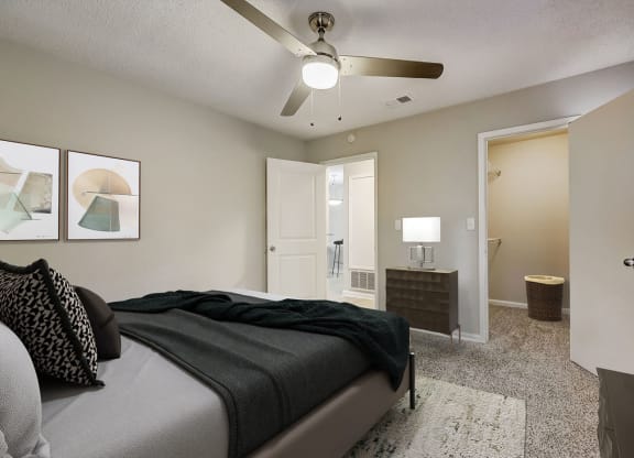 a bedroom with a bed and a ceiling fan