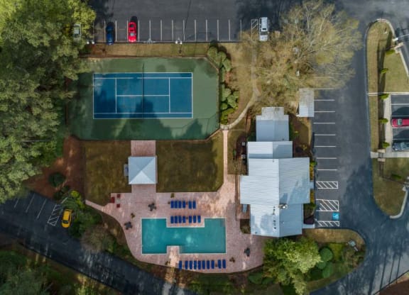 an aerial view of a house with a tennis court and tennis court