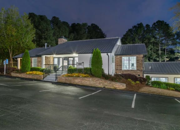 Clubhouse entrace to Veridian at Sandy Springs apartments and a parking lot in front of it
