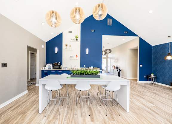 A modern kitchen with a dining table and chairs.