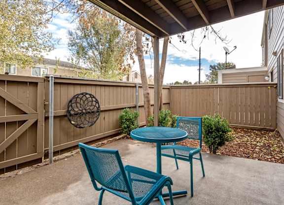 A patio with a table and two chairs at The Ranch at Bear Creek Apartments, Lakewood, 80227