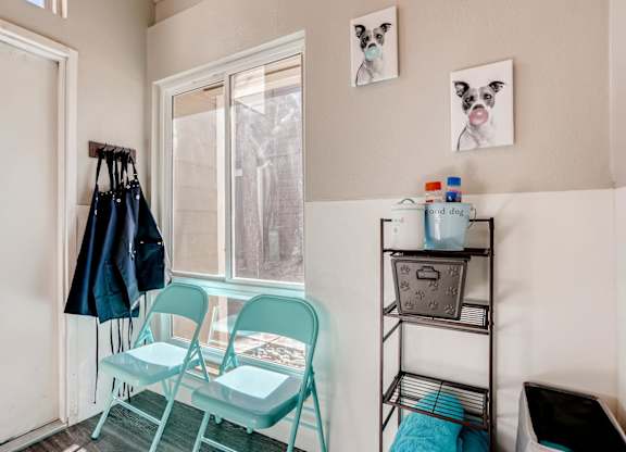 A room with a chair, a table, and a window at The Ranch at Bear Creek Apartments, Lakewood