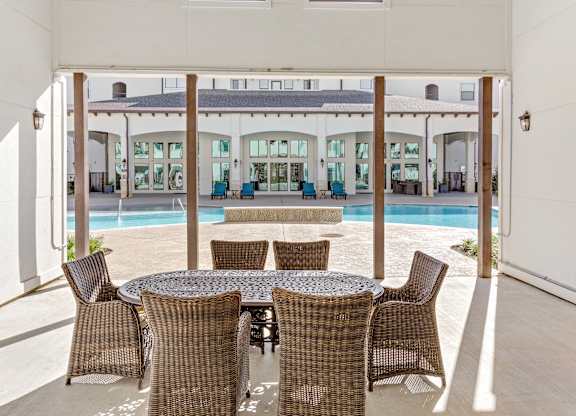Patio with table and chairs at The Laurel at Vintage Park 55+ Apartments, Tomball, TX, 77377