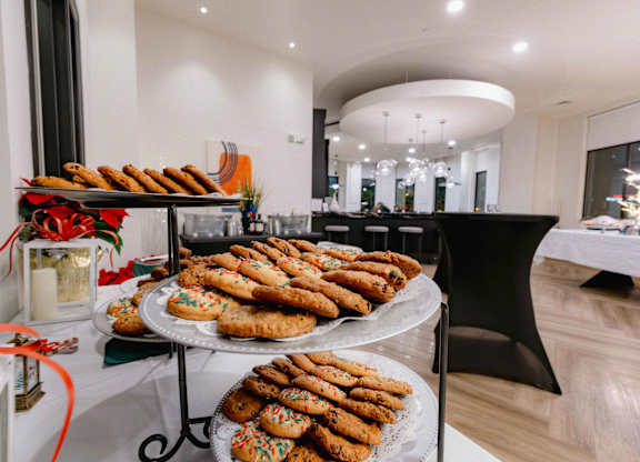 A dessert table with cookies and cakes is set up in a room with a white tablecloth at Metro 303, Hempstead, NY, 11550