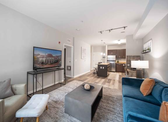 a living room with a couch and a tv at Harbor Pointe, Bayonne, New Jersey