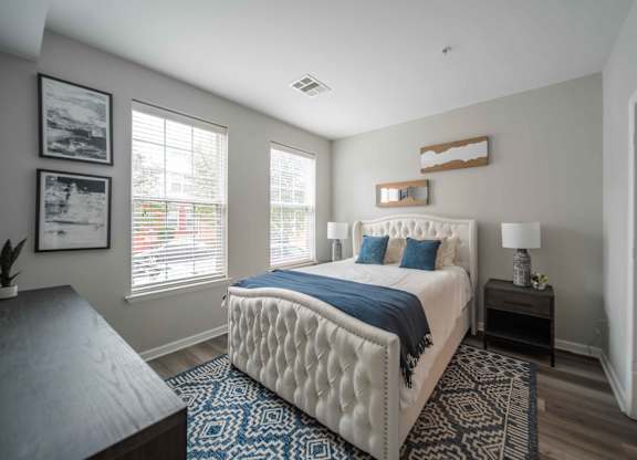 a bedroom with a large bed and two windows  at Harbor Pointe, Bayonne, NJ, 07002
