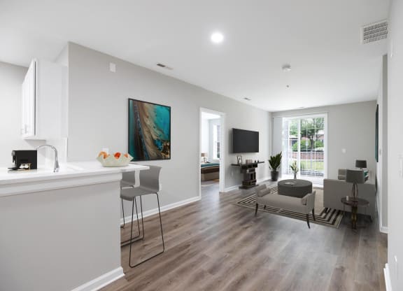 an open living room and kitchen with a table and chairs and a couch at The Lena, Raritan, NJ 08869