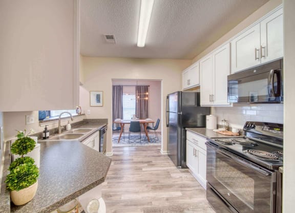 a kitchen with white cabinets at Meridian Obici, Virginia, 23434
