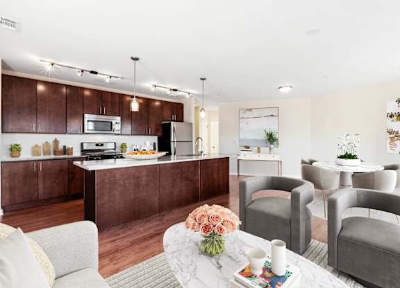 A modern kitchen with brown cabinets and a white island  at Metro 303, Hempstead, NY, 11550