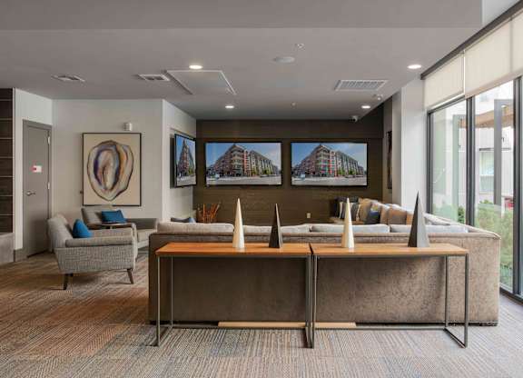 A modern office space with a large desk and a couch at Regatta Sloans Lake Apartments, Denver