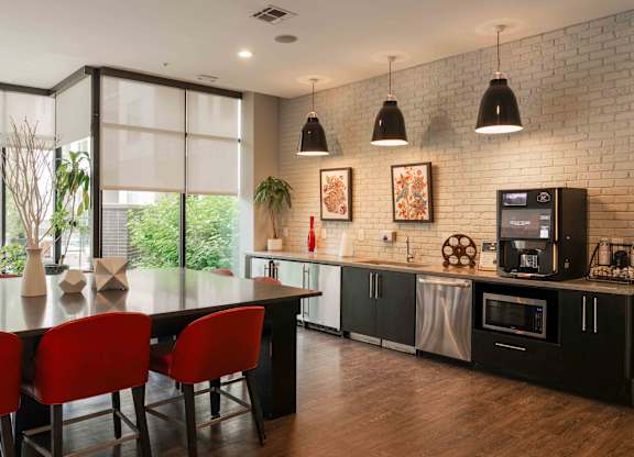 A modern kitchen with a dining table and chairs at Regatta Sloans Lake Apartments, Denver