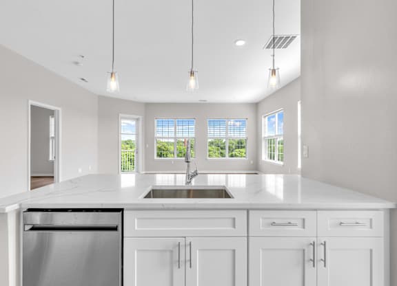 A modern kitchen with white cabinets and a large island.