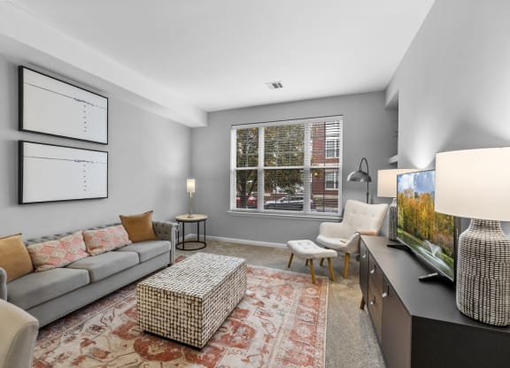 a spacious living room with a large window  at Harbor Pointe, Bayonne, New Jersey