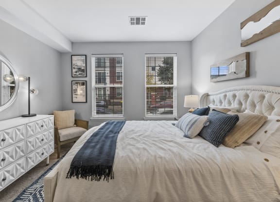 a bedroom with a large bed and two windows  at Harbor Pointe, New Jersey, 07002