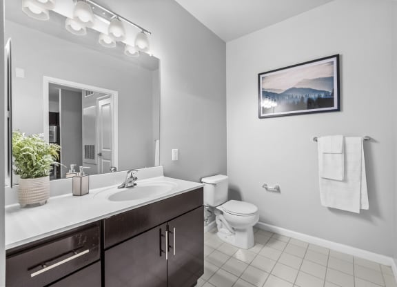 a bathroom with a toilet sink and mirror  at Harbor Pointe, Bayonne, New Jersey