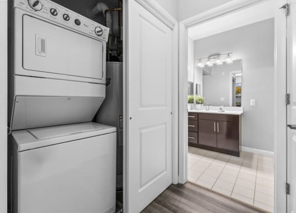 a washer and dryer in a kitchen with a bathroom in the background  at Harbor Pointe, Bayonne, New Jersey