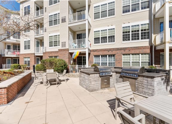 Courtyard with a grill and tables and chairs at The Lena, Raritan, 08869