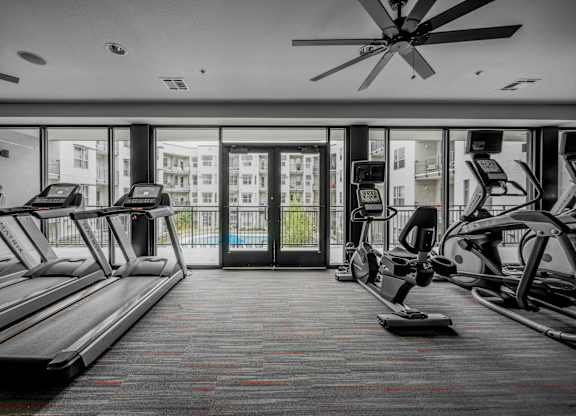 A gym with treadmills and elliptical machines at Regatta Sloans Lake Apartments, Denver, CO
