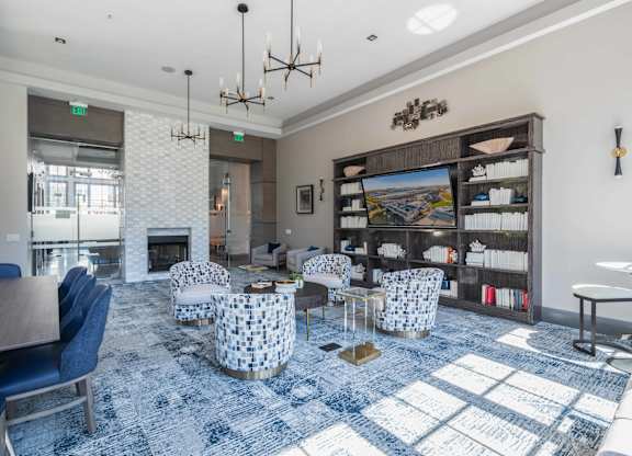 A large room with a fireplace and a blue carpet.