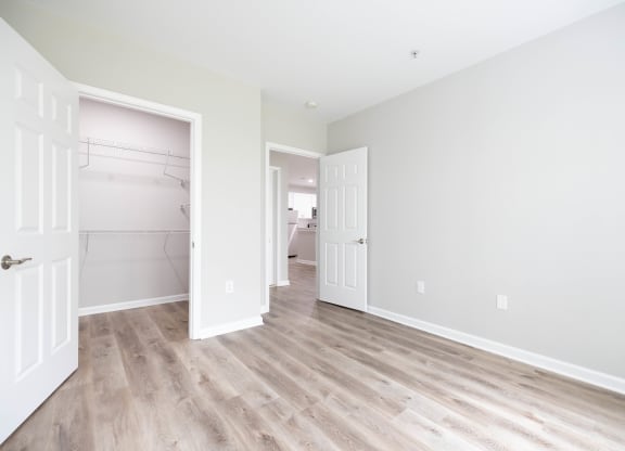 an empty bedroom with a closet and a door to a bathroom at The Lena, Raritan, NJ 08869