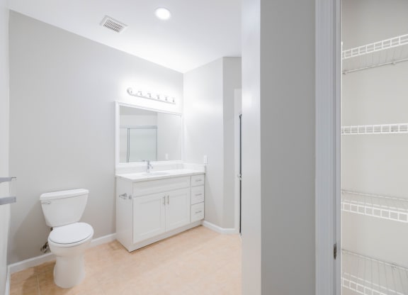 a white bathroom with a toilet and a sink at The Lena, Raritan, NJ 08869