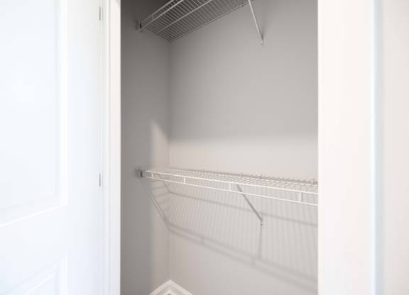Empty white shelves in a white room.