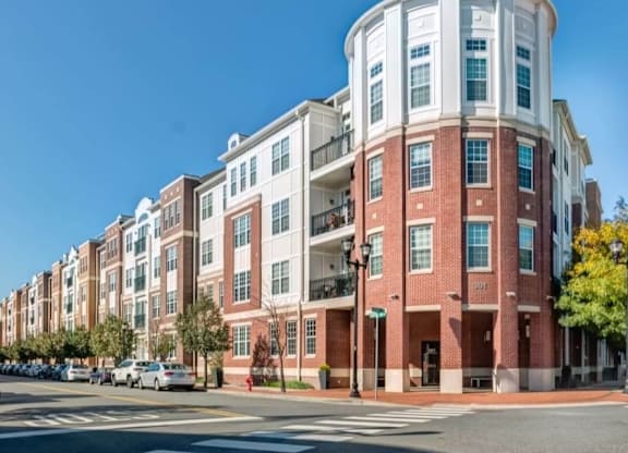 A red brick building with a white section on the top floor.