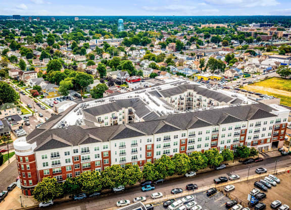 an aerial view of a large building in a city at Metro 303, Hempstead, NY