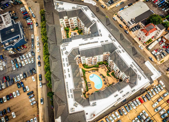 an aerial view of an apartment complex with a swimming pool and parking lot at Metro 303, Hempstead New York