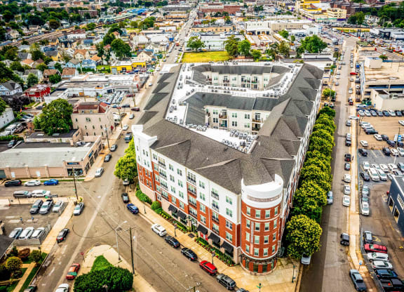 an aerial view of a large brick building with a gray roof at Metro 303, Hempstead