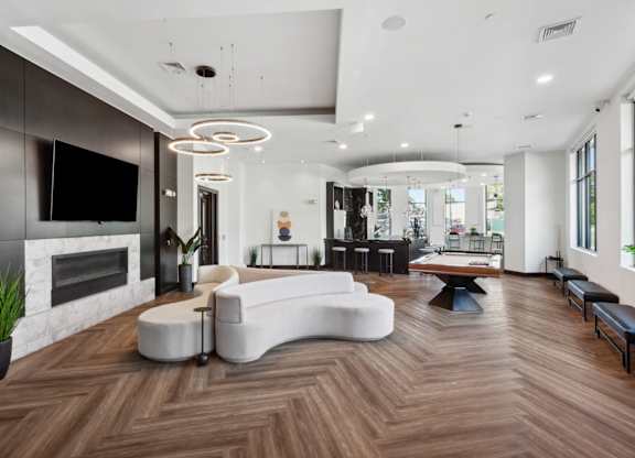 Modern living room with a fireplace and a white sofa at Metro 303, Hempstead, NY