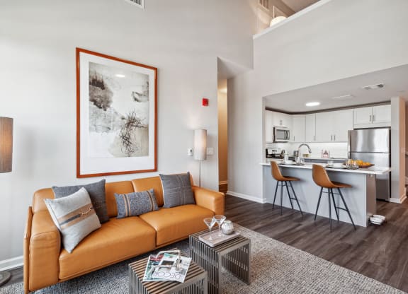 a living room with a couch coffee table and a kitchen in the background at Metro 303, New York