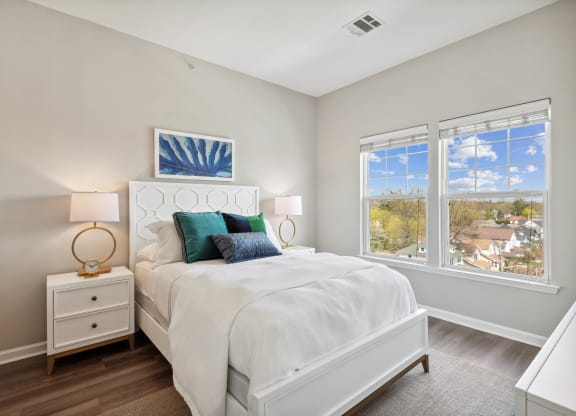 a bedroom with a bed and two windows at Metro 303, New York