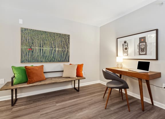 a room with a desk and chair and a painting on the wall at Metro 303, Hempstead New York