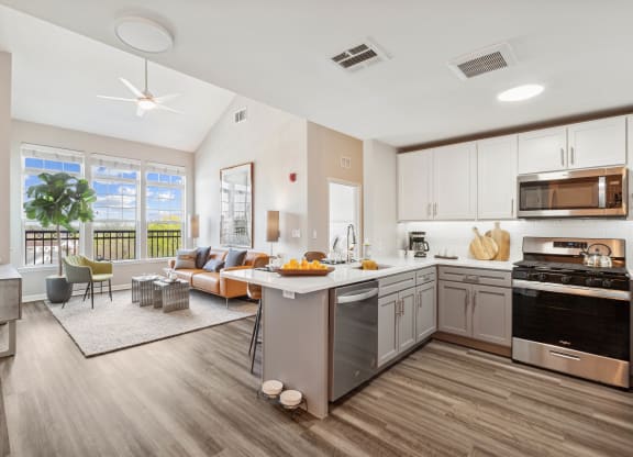a kitchen and living room with a large window at Metro 303, Hempstead New York