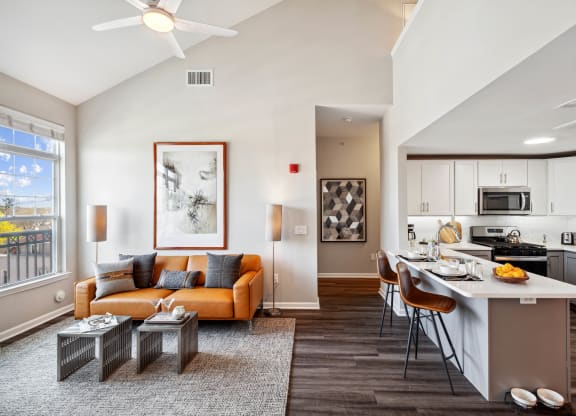 our apartments offer a living room with a couch a coffee table and a kitchen with a breakfast at Metro 303, Hempstead New York