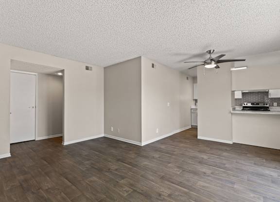 A room with a ceiling fan and wooden flooring at The Ranch at Bear Creek Apartments, Lakewood, CO, 80227